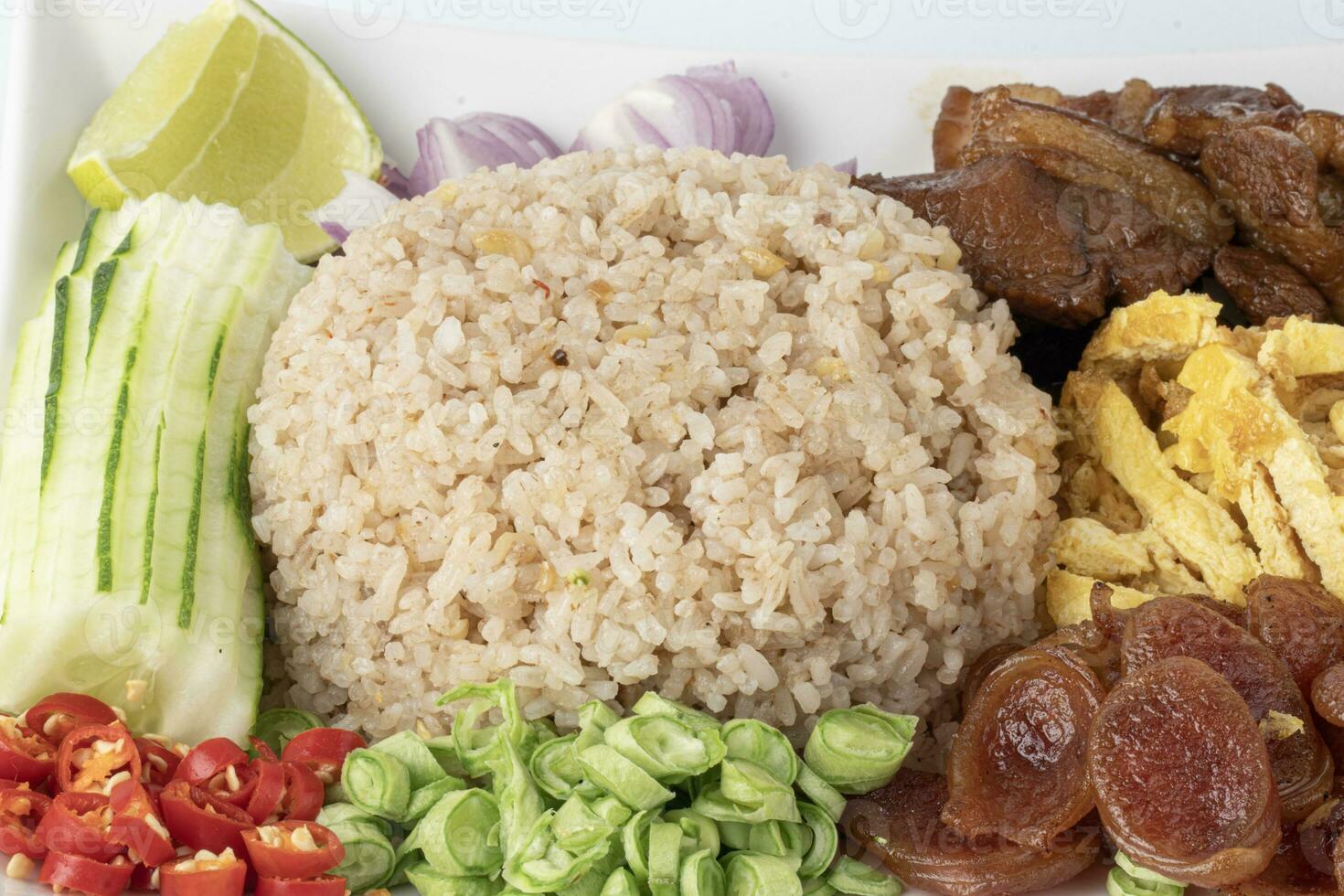 Close up Fried Rice with Shrimp Paste Stir fried rice with shrimp paste, served with fried Chinese sausage, slices of omelettete, and vegetables photo