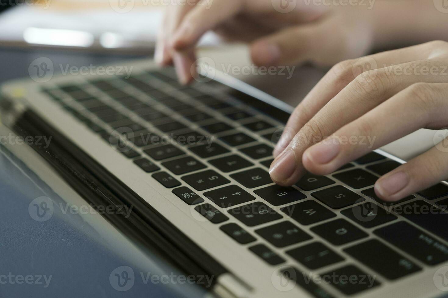 Closeup shot hands using laptop computer photo