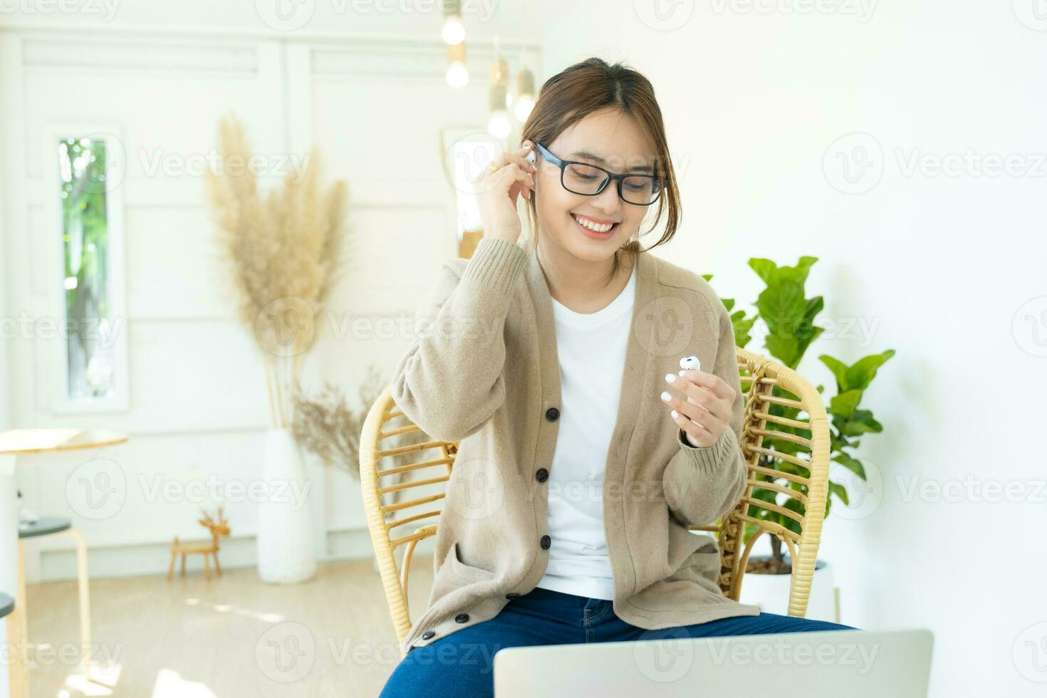 Young woman using wireless headphone listening to music. photo