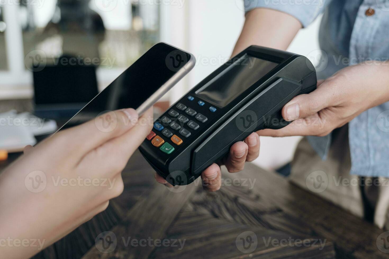 Paying bill through smartphone using NFC technology. photo
