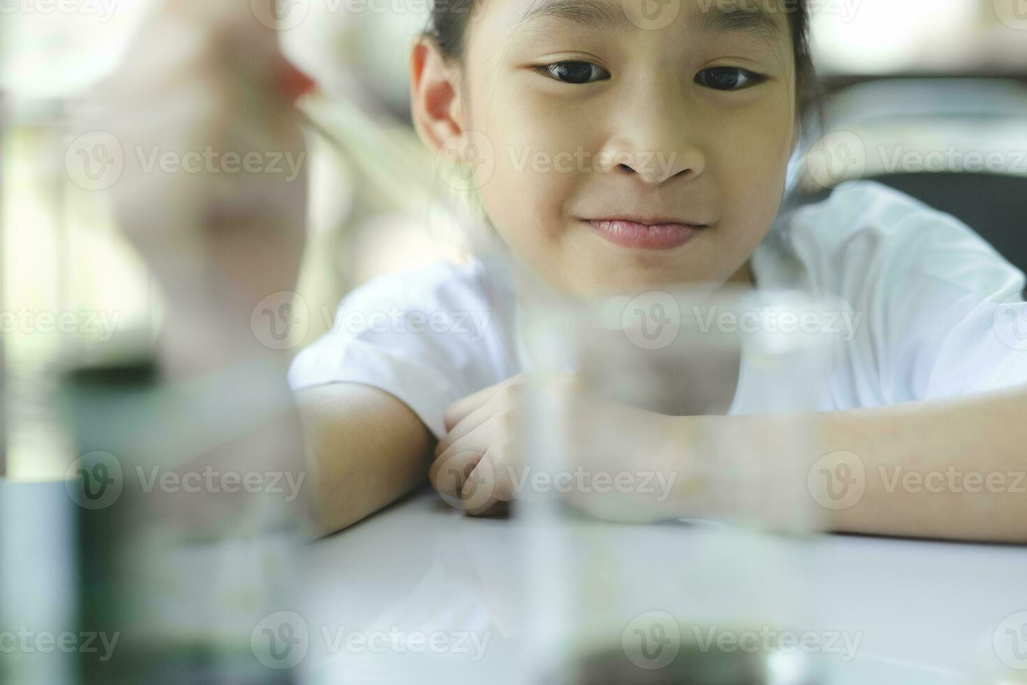 Little child with learning science class in school laboratory photo