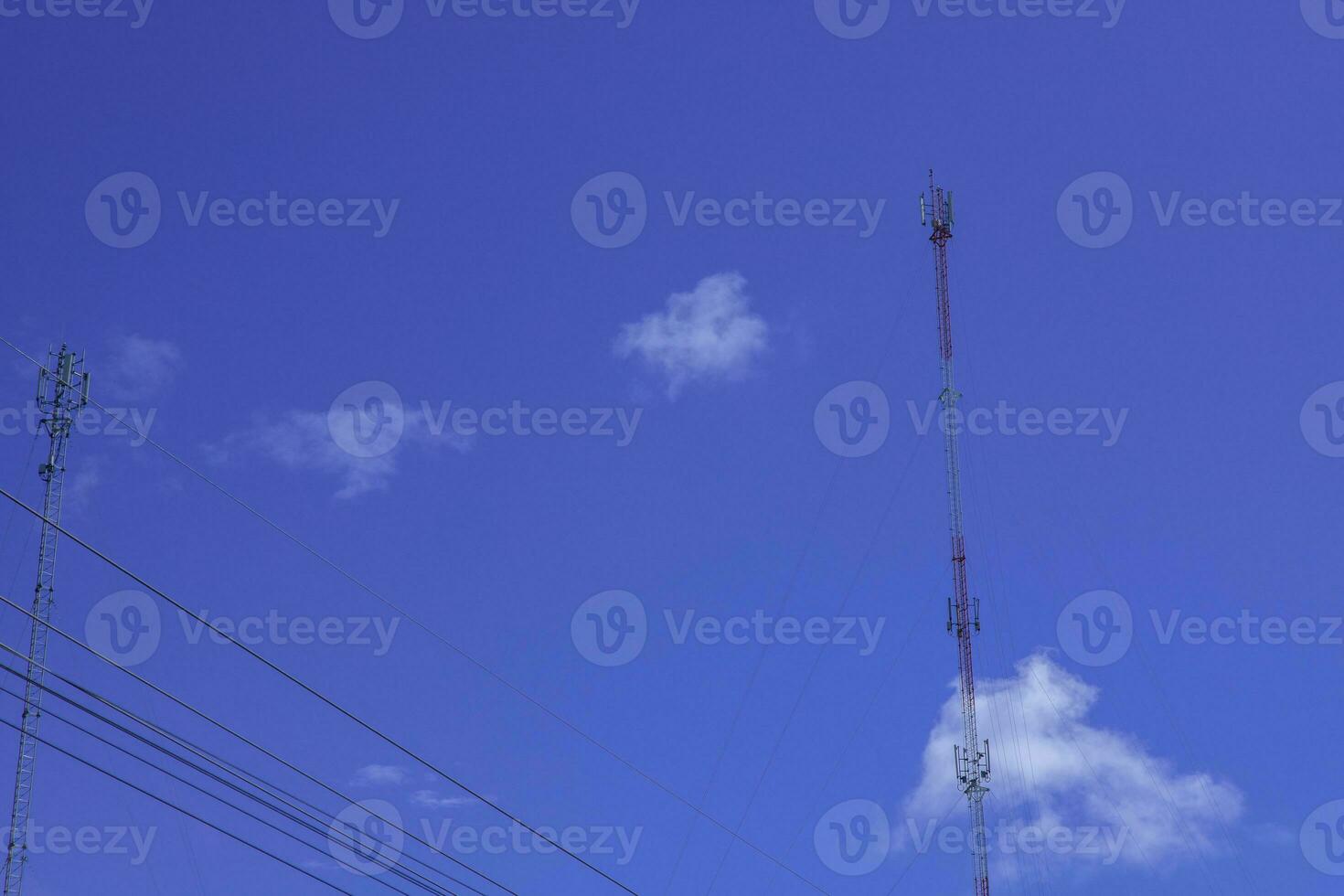 telephone signal tall pole  on blue clear sky background photo
