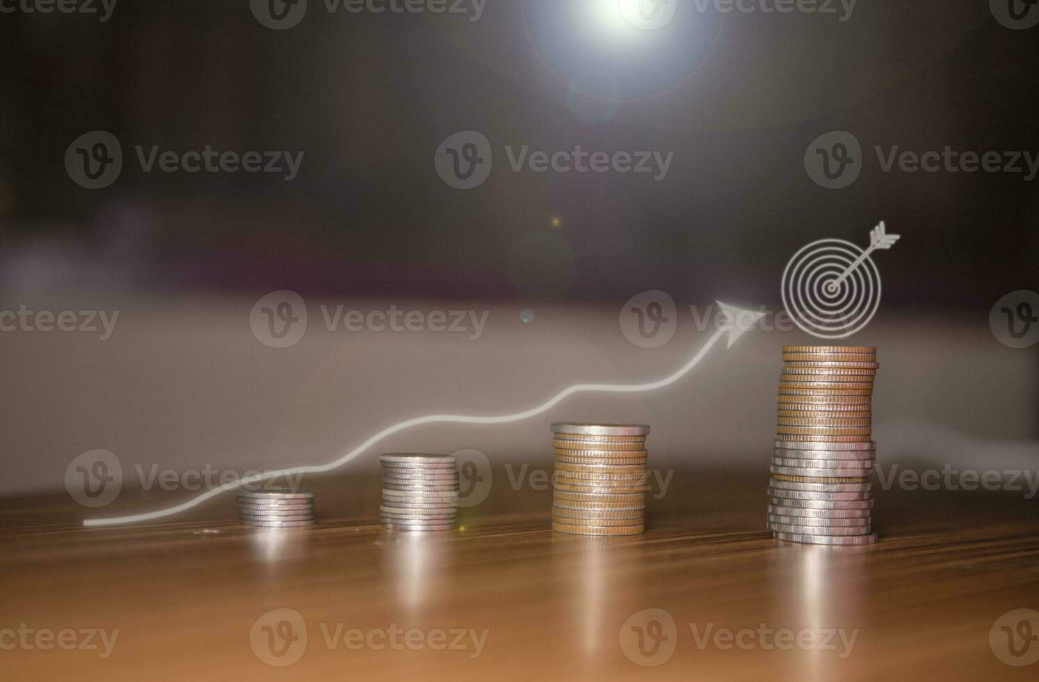 Stacking coins on the wooden table and growth graph line chart target to save money or investment of business concept income by finance  marketing photo
