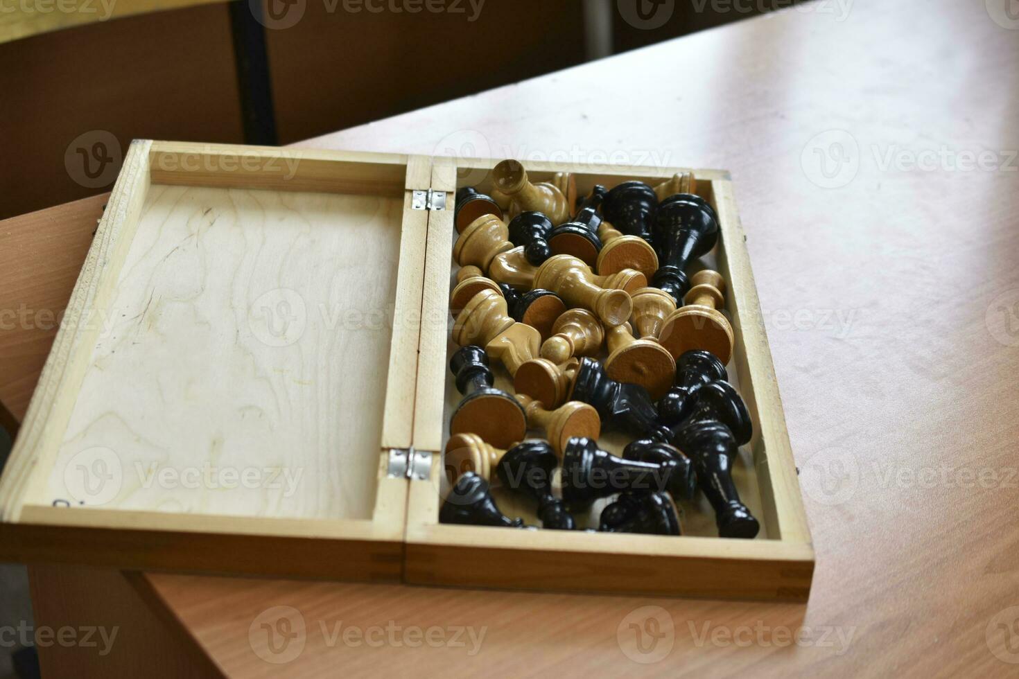 The chessboard is on the table. Chess pieces in the board. Chess set. photo