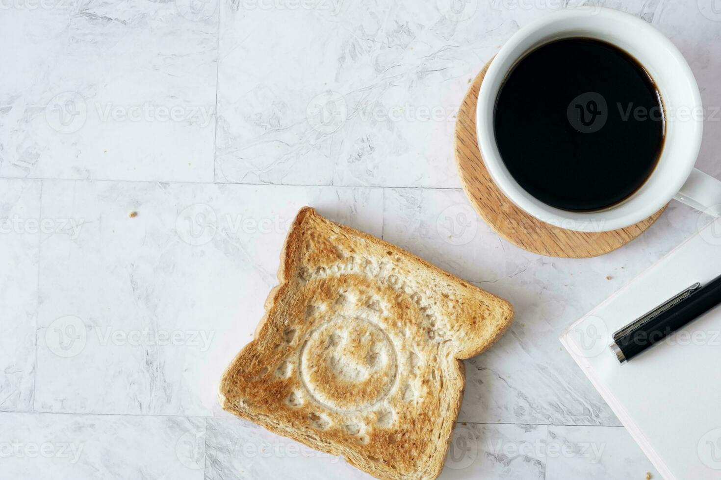 Topview flat lay of working table with coffee and toast bread. photo