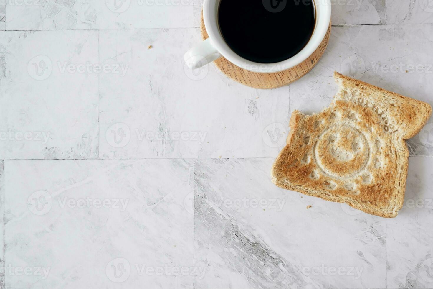 Topview flat lay of working table with coffee and toast bread. photo