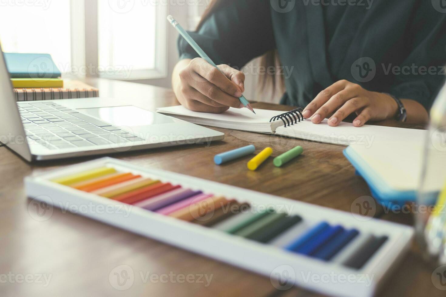 Close up hands with pen writing on notebook. photo