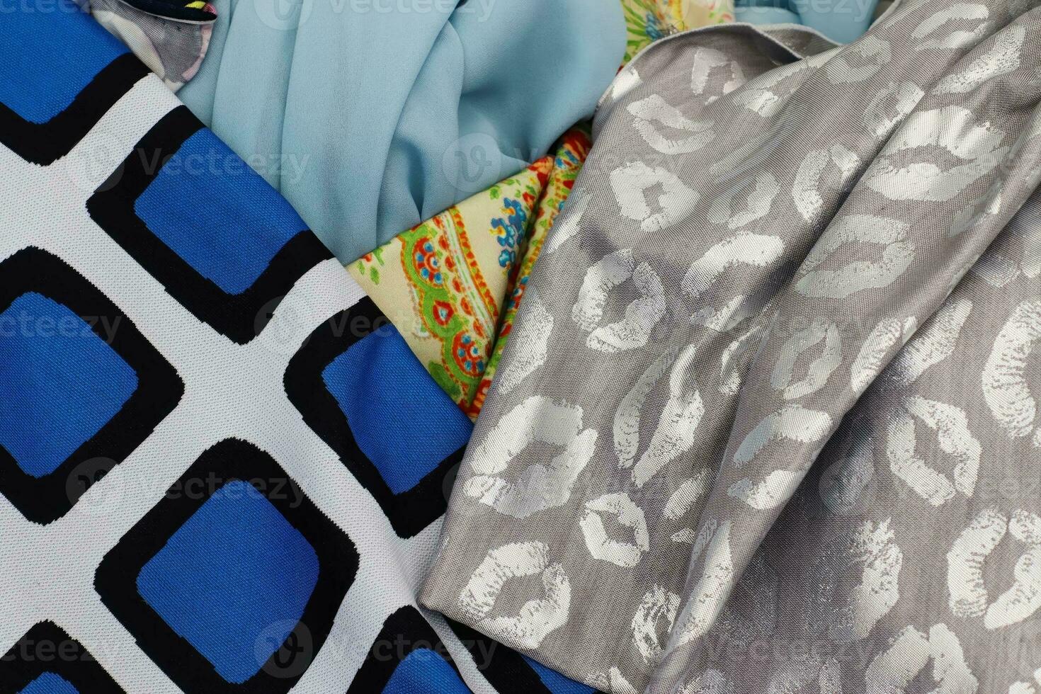 Detailed close up view on samples of cloth and fabrics in different colors found at a fabrics market photo