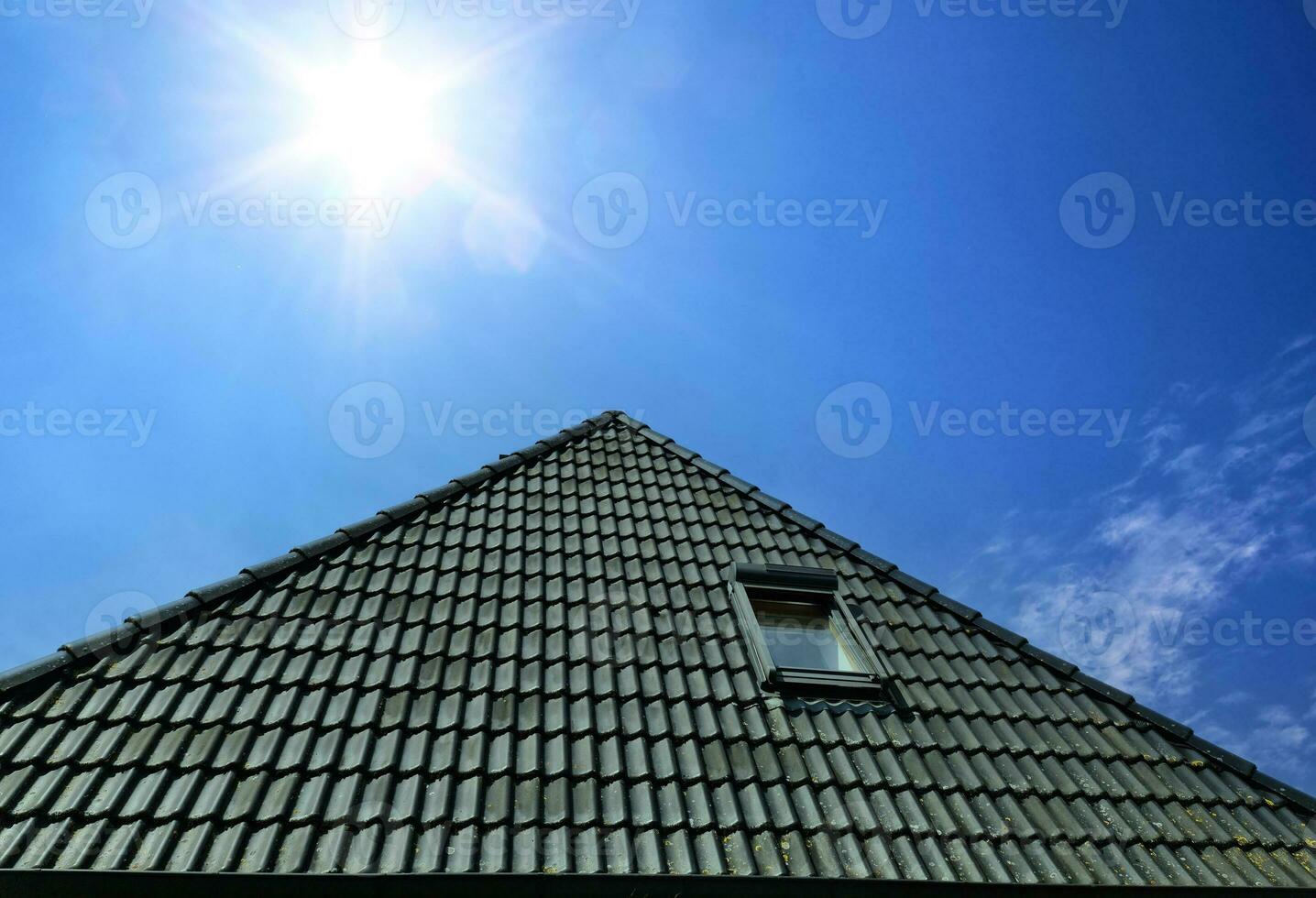 Open roof window in velux style with black roof tiles. photo