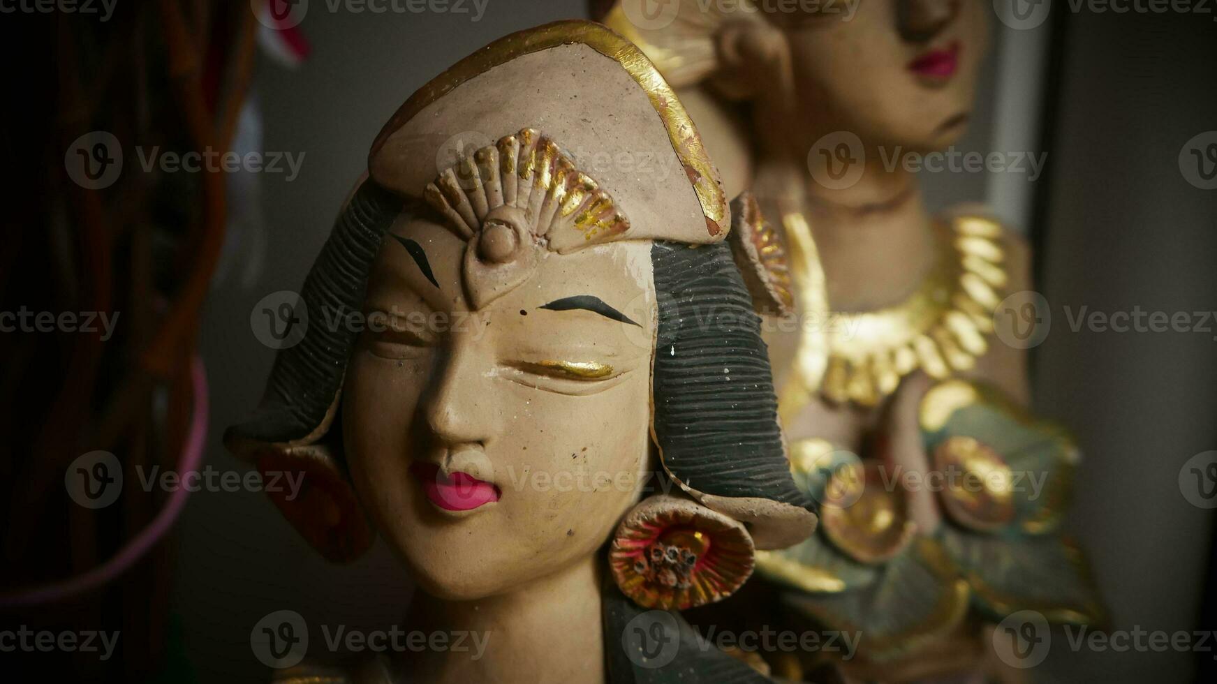 Beautiful artistic statue of a Balinese or javanese dancer used as garden decoration, javanese gnome indonesia photo