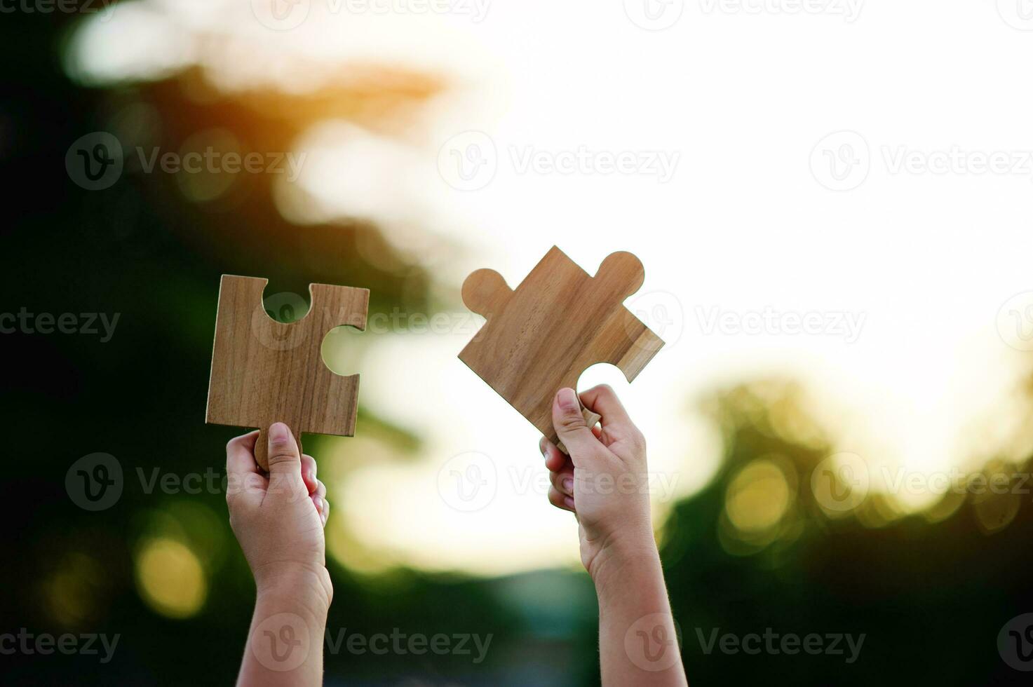 Jigsaw in hand, a puzzle piece that is critical to success. Creativity, ideas, initiative, unity, teamwork photo