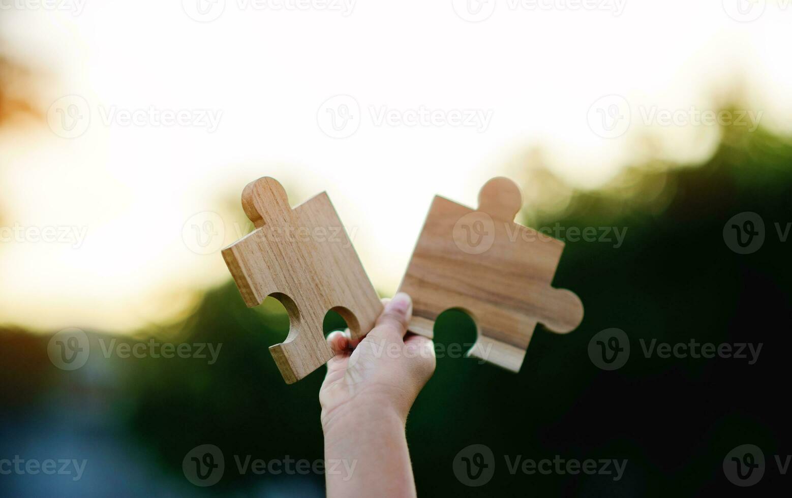 Jigsaw in hand, a puzzle piece that is critical to success. Creativity, ideas, initiative, unity, teamwork photo