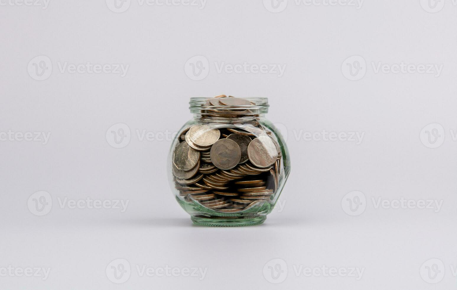 Saving coins in a glass jar saving money to build the future Saving money for business. Income. Salary. Savings concept. photo