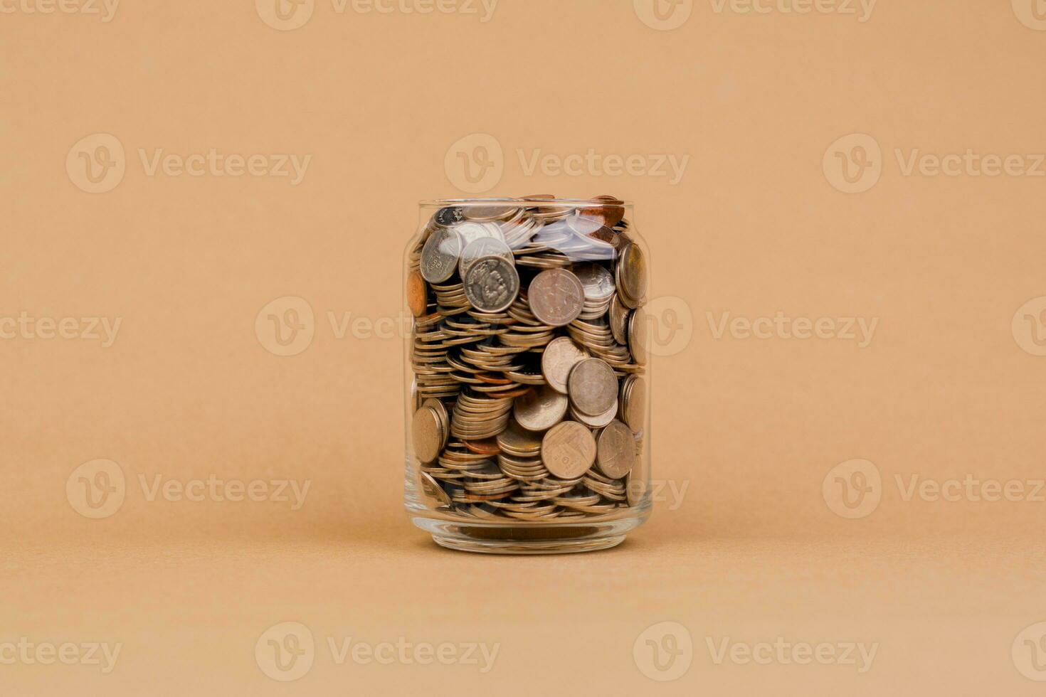 Saving money in a glass jar, coin, financial system, income, salary, investment, financial tax, profit, return on investment concept of saving money and financial investment photo