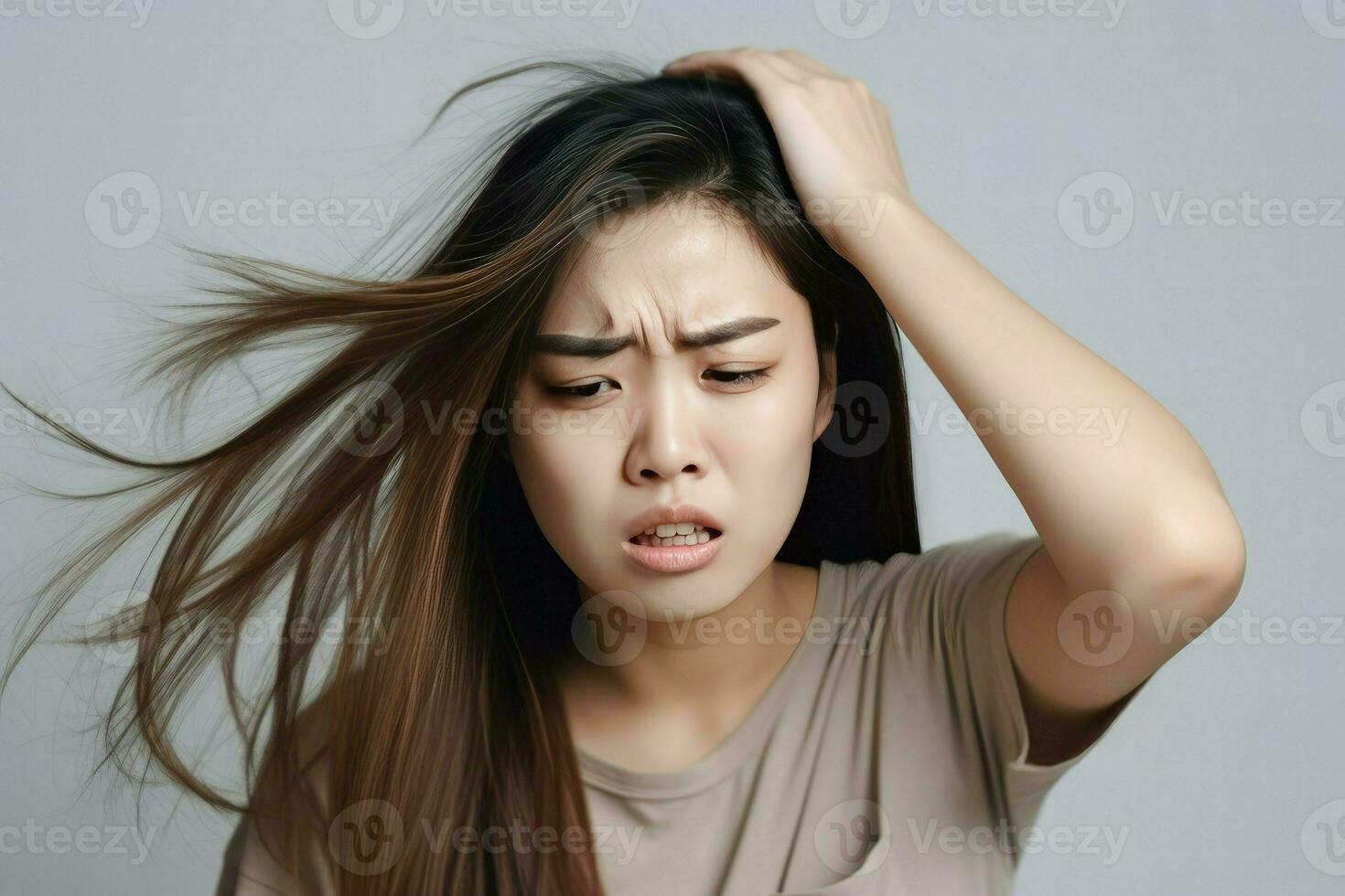 sad young woman with a brush in her messy hair and hair loss photo