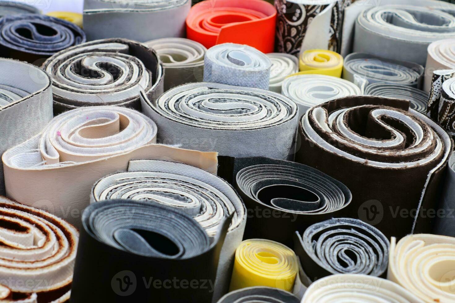 Detailed close up view on samples of cloth and fabrics in different colors found at a fabrics market photo