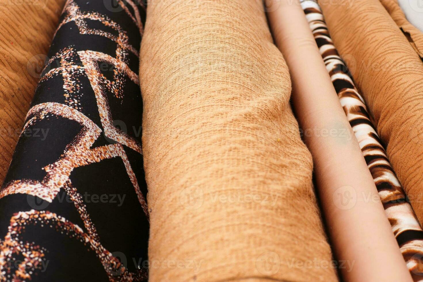 Detailed close up view on samples of cloth and fabrics in different colors found at a fabrics market photo