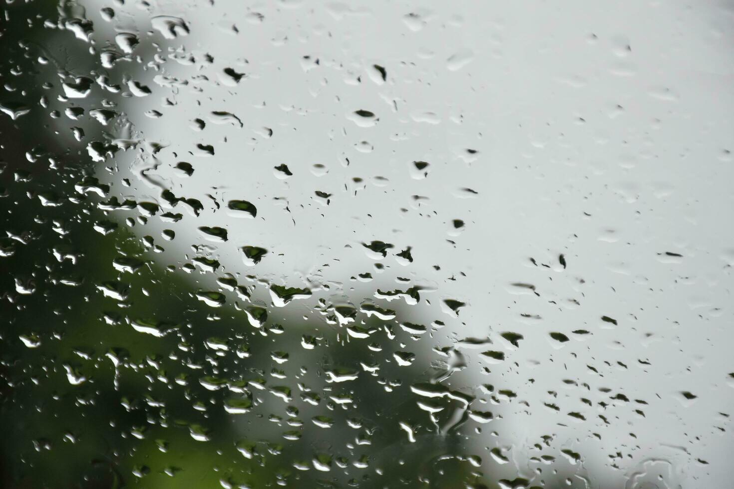 Blurred image of raindrops on the rear view mirror of car, soft focus photo