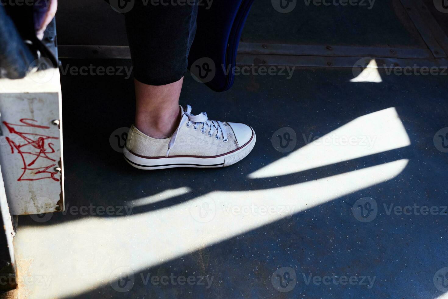 foto de blanco zapatillas en mujer pierna en contra