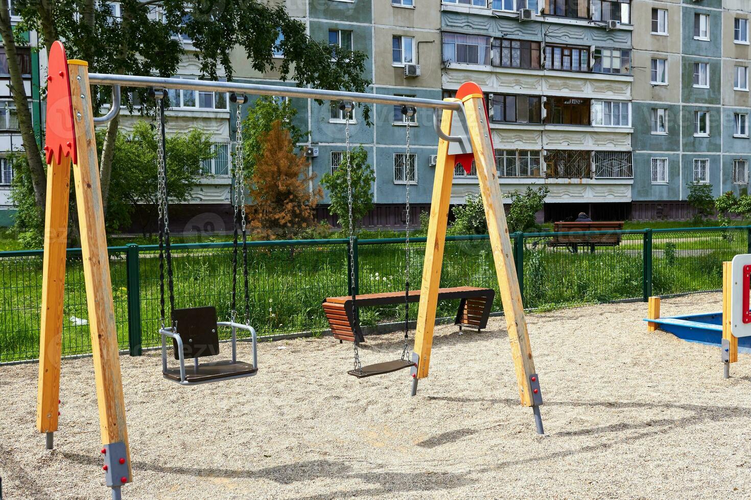 Photo of children swing on iron chains playground