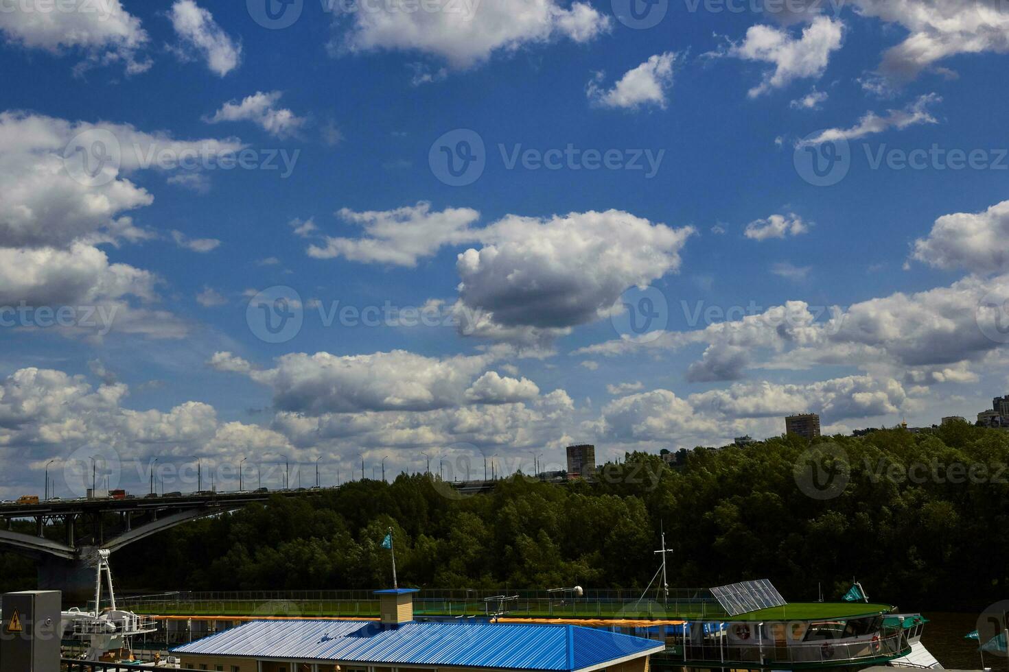 blue sky with clouds bridge over river trees. photo
