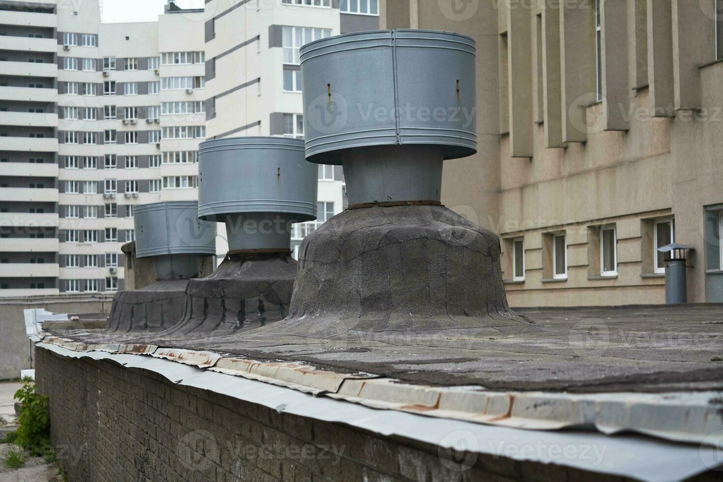 large metal pipes ventilation system. Multi story houses. City. photo