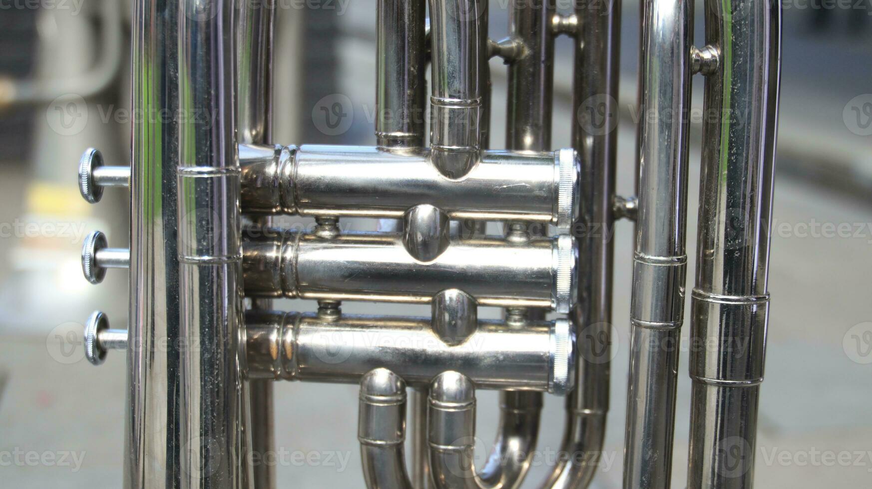 Close up on a valve section of a professional trumpet photo