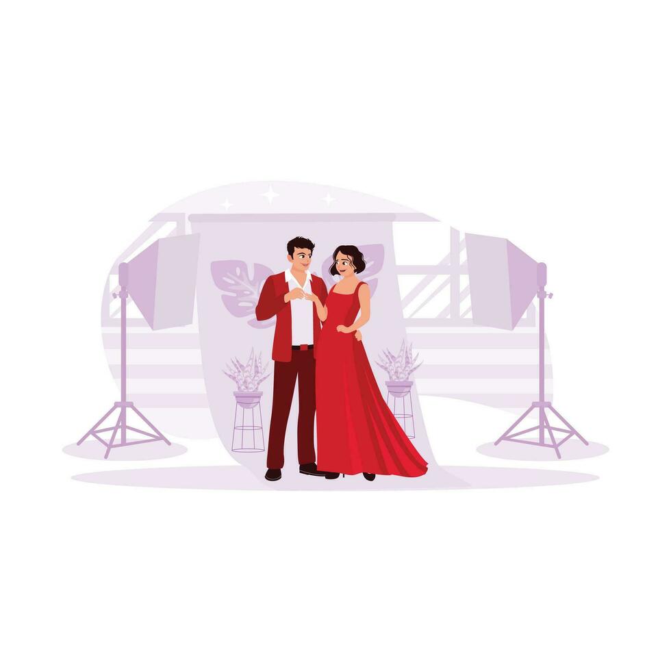 Portrait of a young couple, excited to do a photoshoot. In a studio complete with beautiful flower backgrounds and shining lights. Trend modern vector flat illustration.