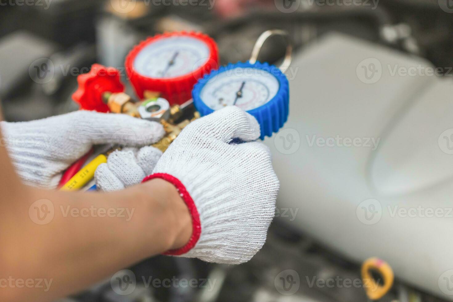 Repairman holding monitor tool to check and fixed car air conditioner system, Technician check car air conditioning system refrigerant recharge, Air Conditioning Repair photo