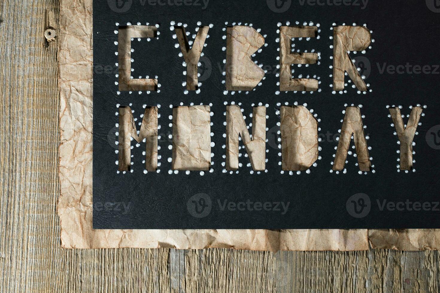 Words CYBER MONDAY on black carton paper photo