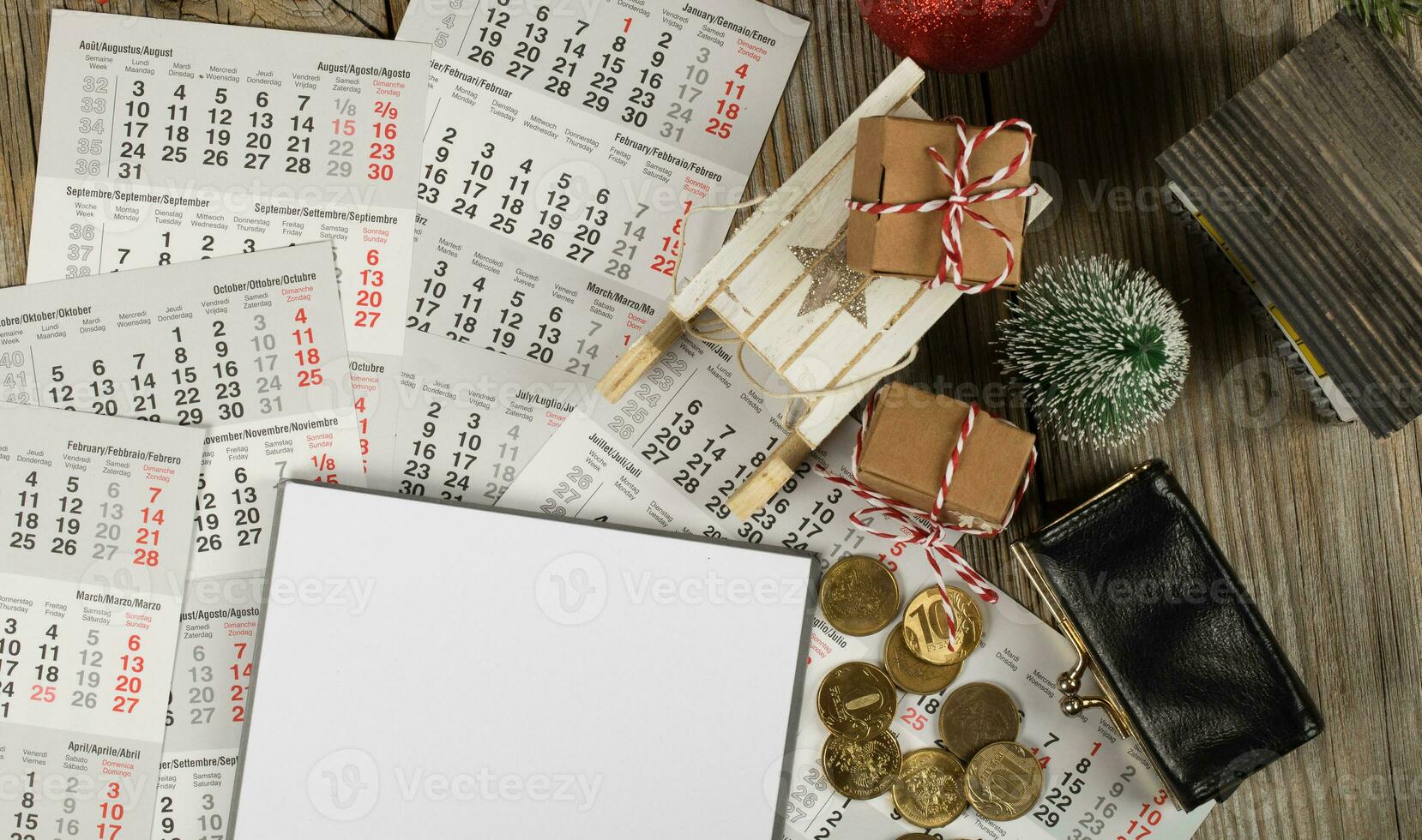 Blank sheet of paper and small purse with coins on the New Year's background. photo