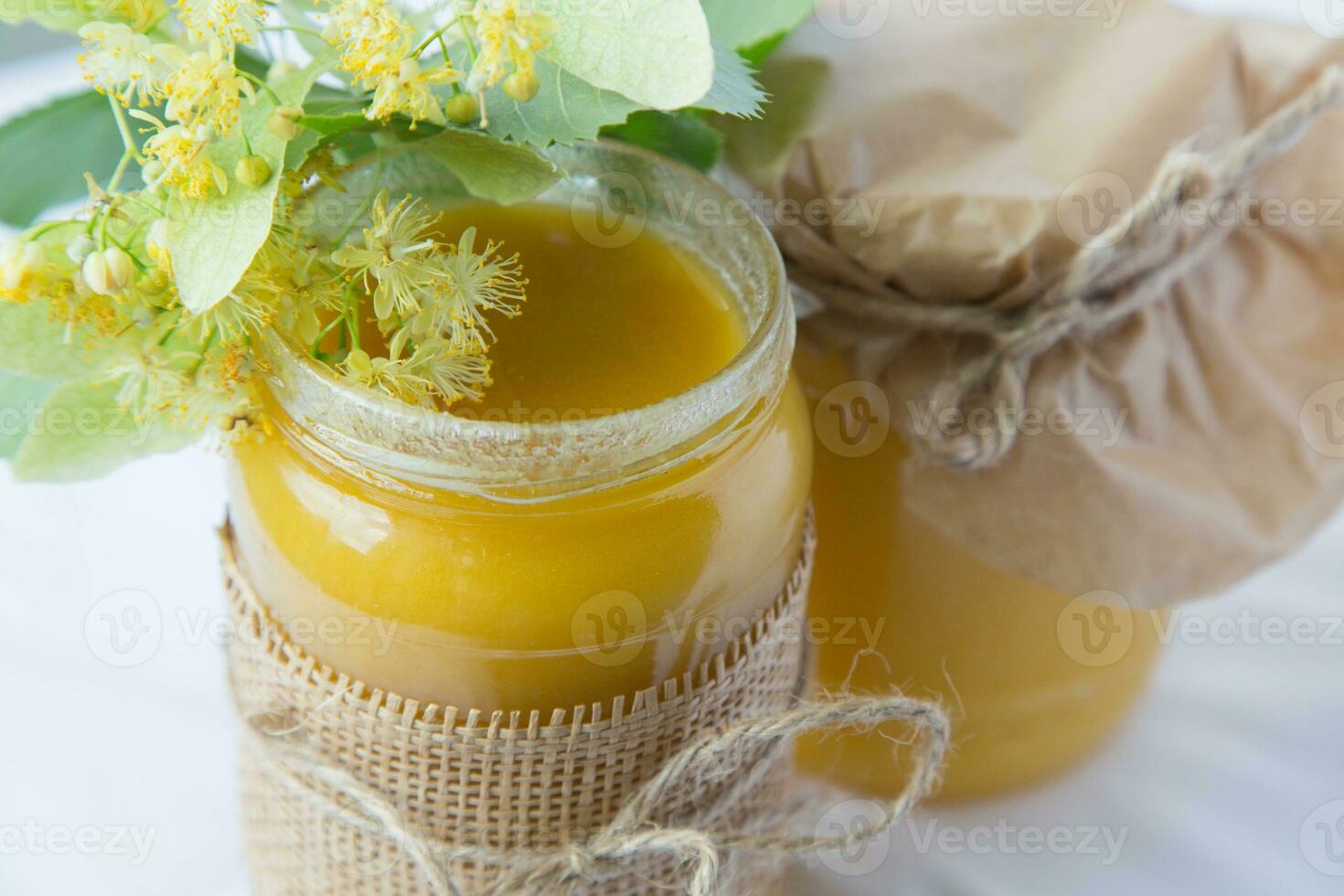 Two bottles of homemade linden honey photo