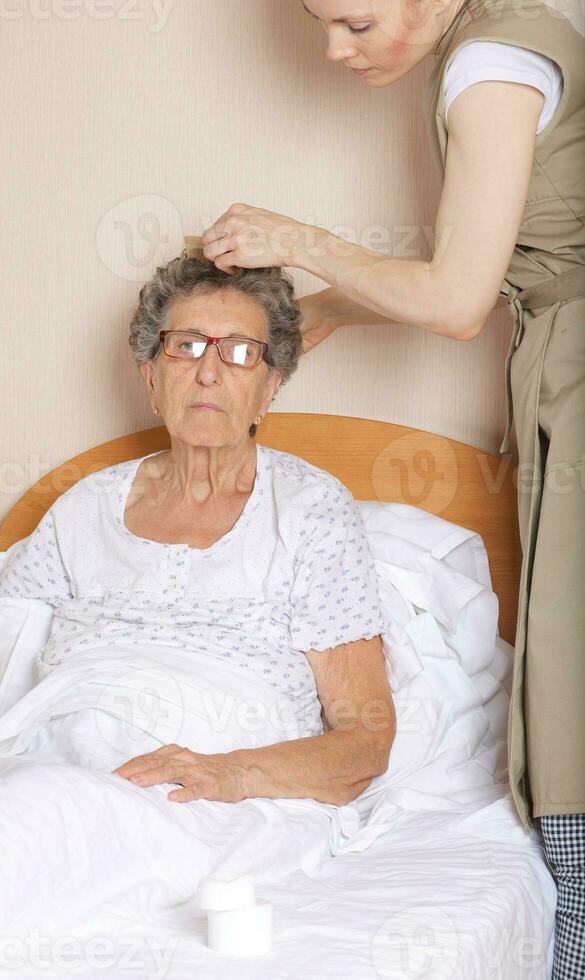 Young social work assistant and senior woman in her room photo