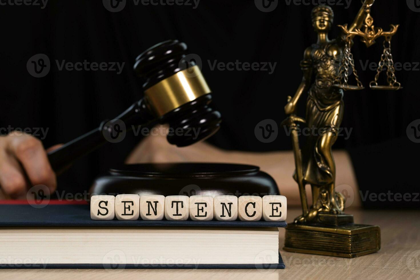 Word SENTENCE composed of wooden dices. Wooden gavel and statue of Themis in the background. photo