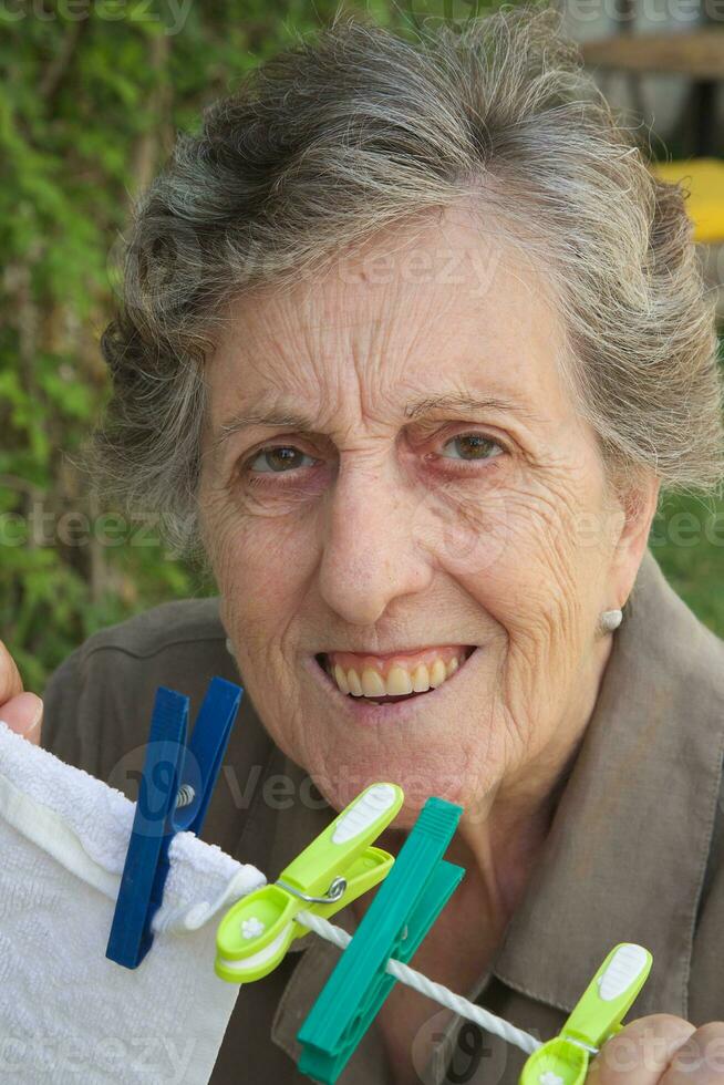 An old smiling woman in the garden photo
