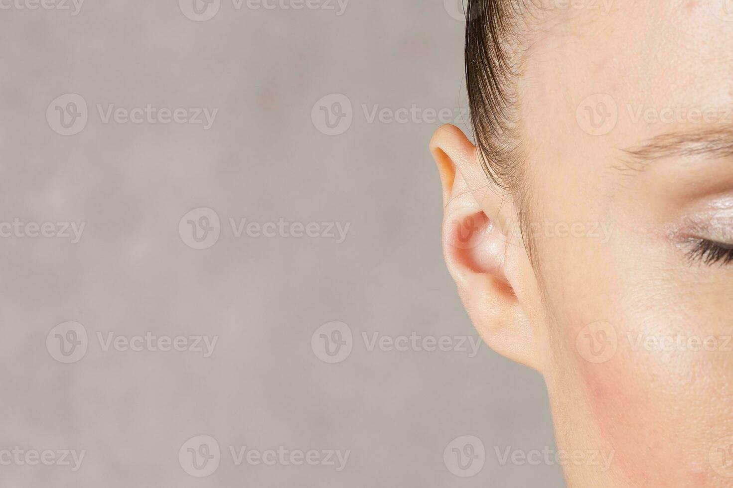 Ear of a young caucasian lady. Closeup photo