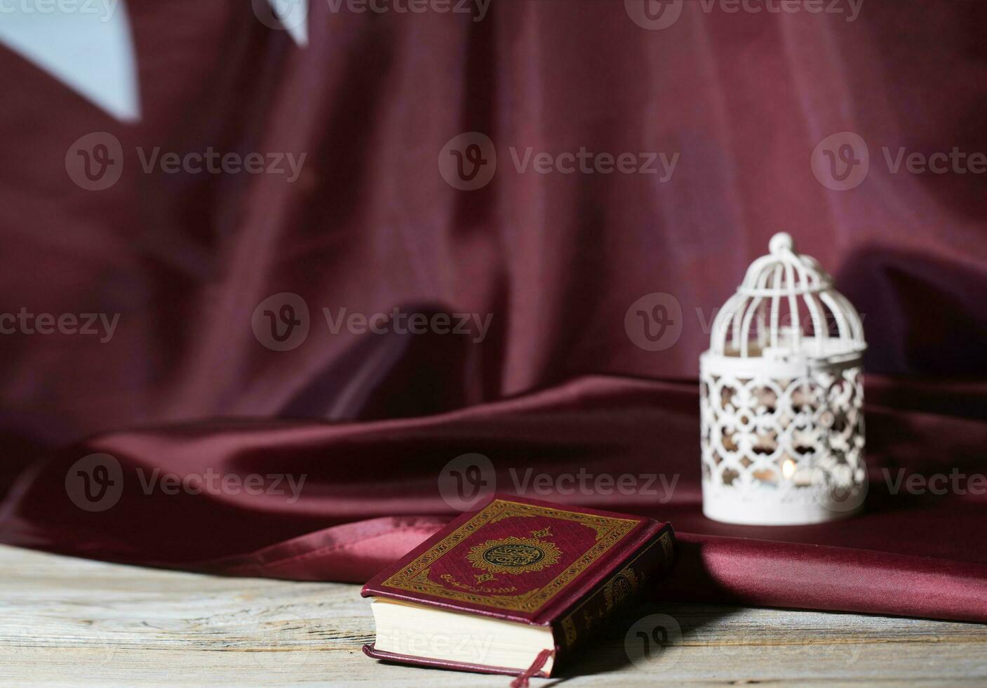 Sacred book of Quran on a wooden surface. photo