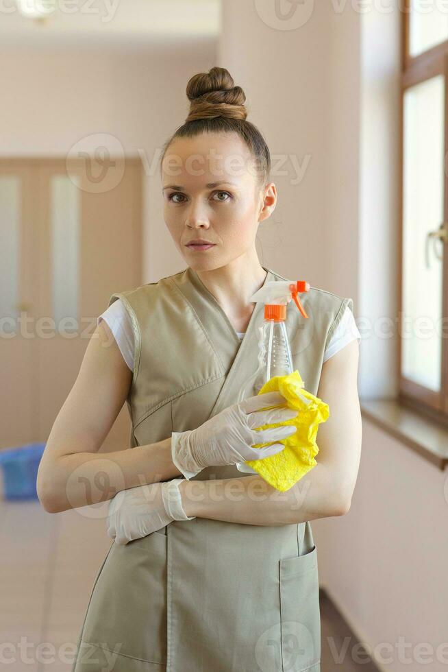 Young cleaning lady is cleaning the corridor. photo