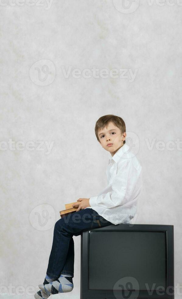 Boy and an old TV. Free space for a text. photo