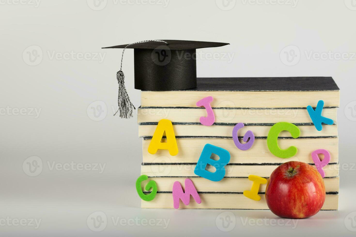 Academic hat on books. Free space for a text. photo