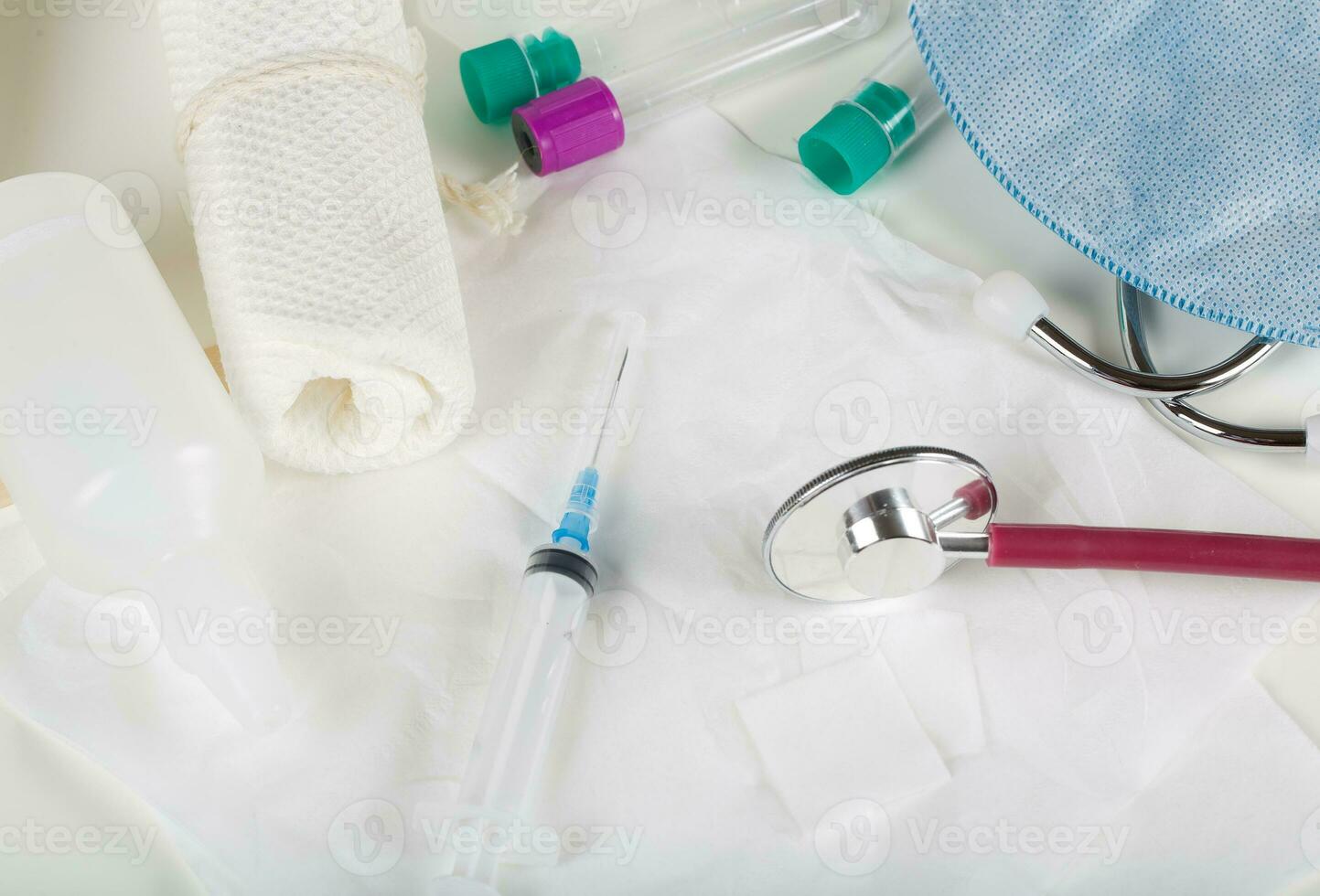 Syringe, alcohol wipe and glass ampule with antibiotics on a white napkin.Top view photo