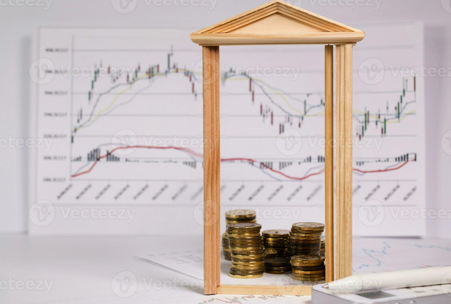 Coins on a stock market charts behind opened small wooden door. photo