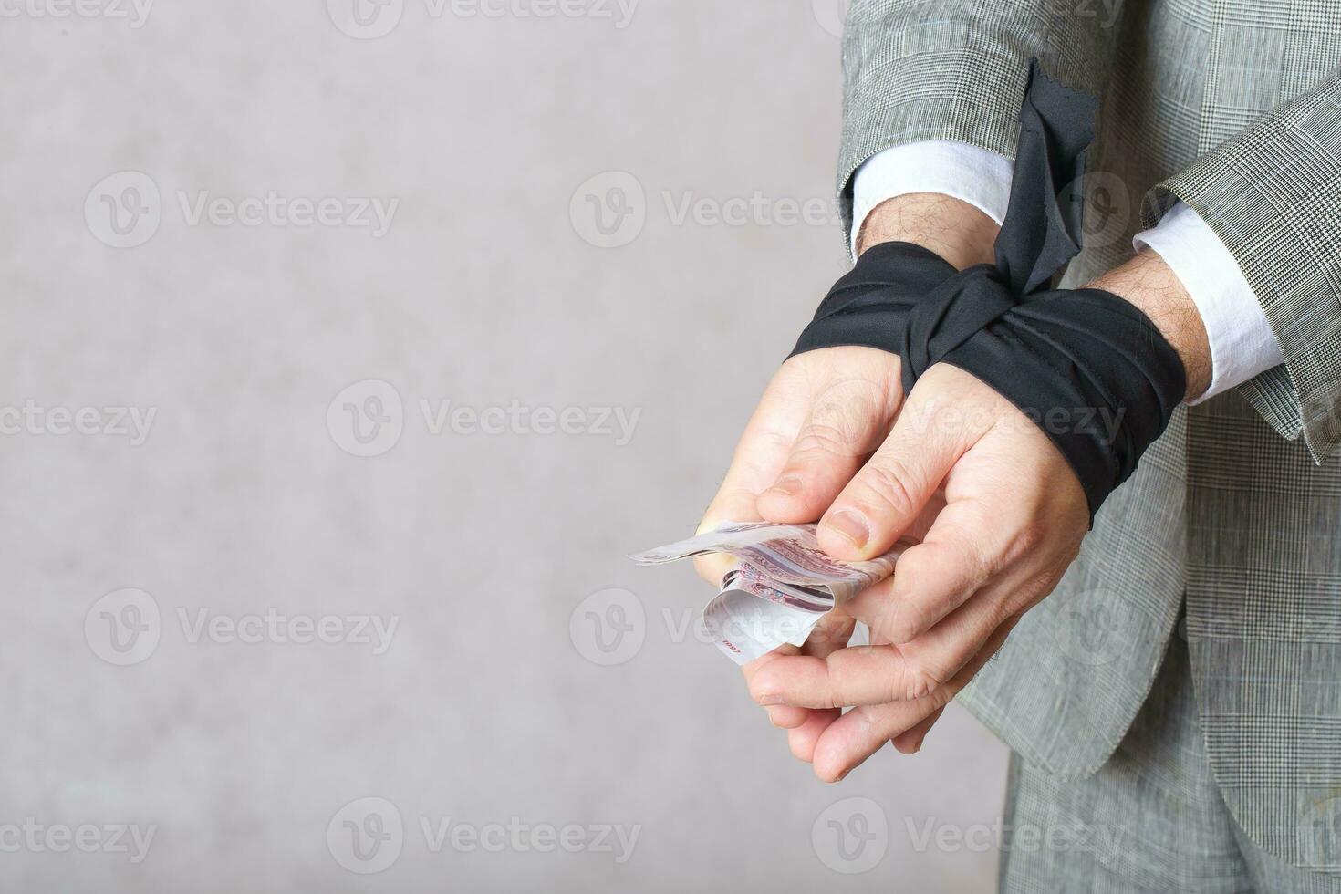 Money in man's tied hands photo