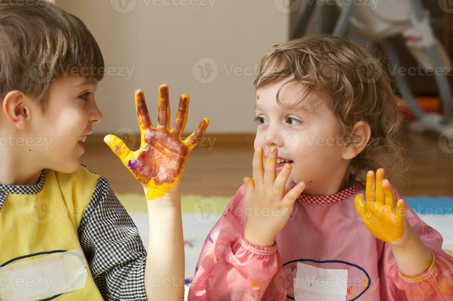Children are painting white blanket with their palms photo