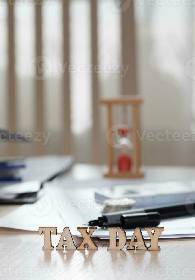 Word TAX DAY composed of wooden letters. Closeup photo