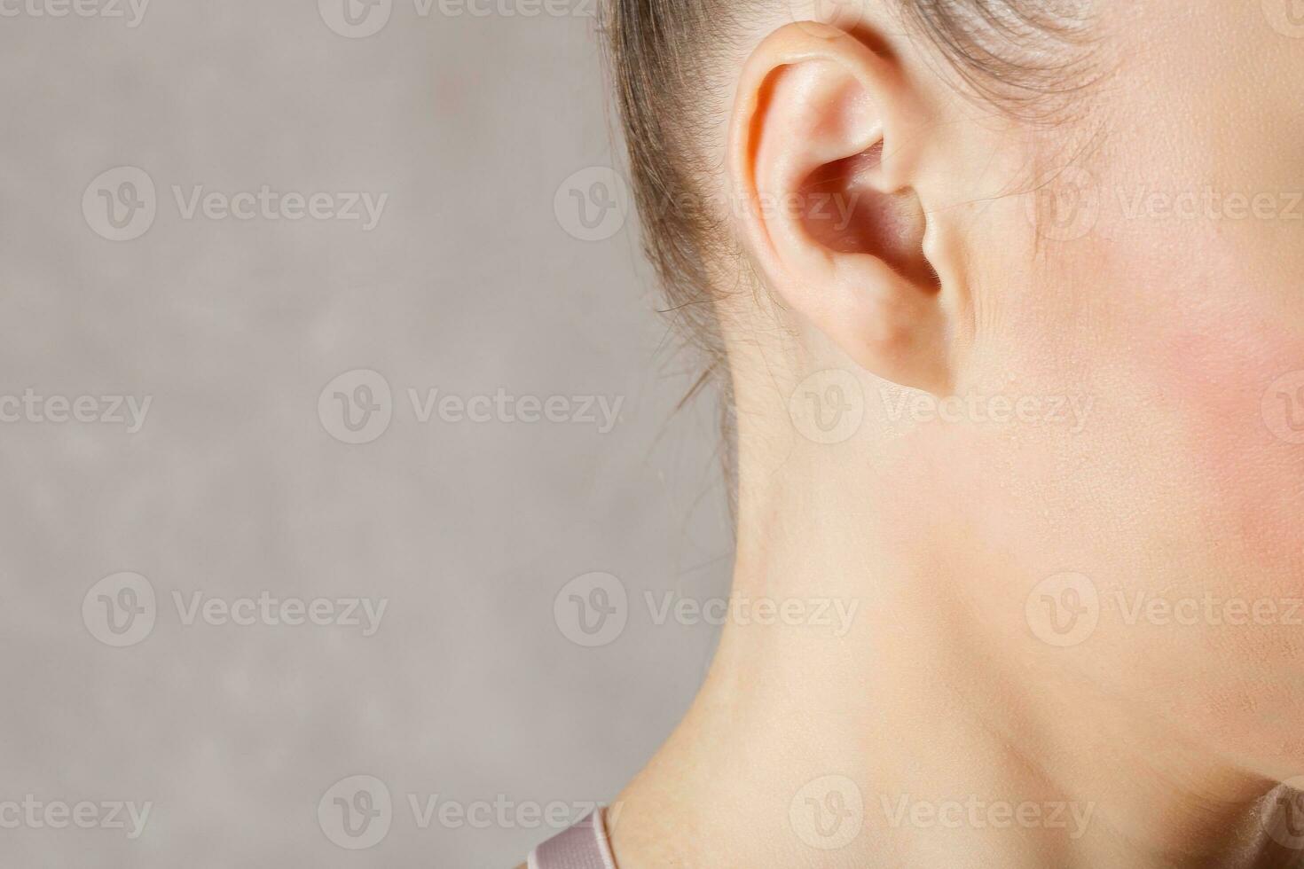 Ear of a young caucasian lady. Closeup photo