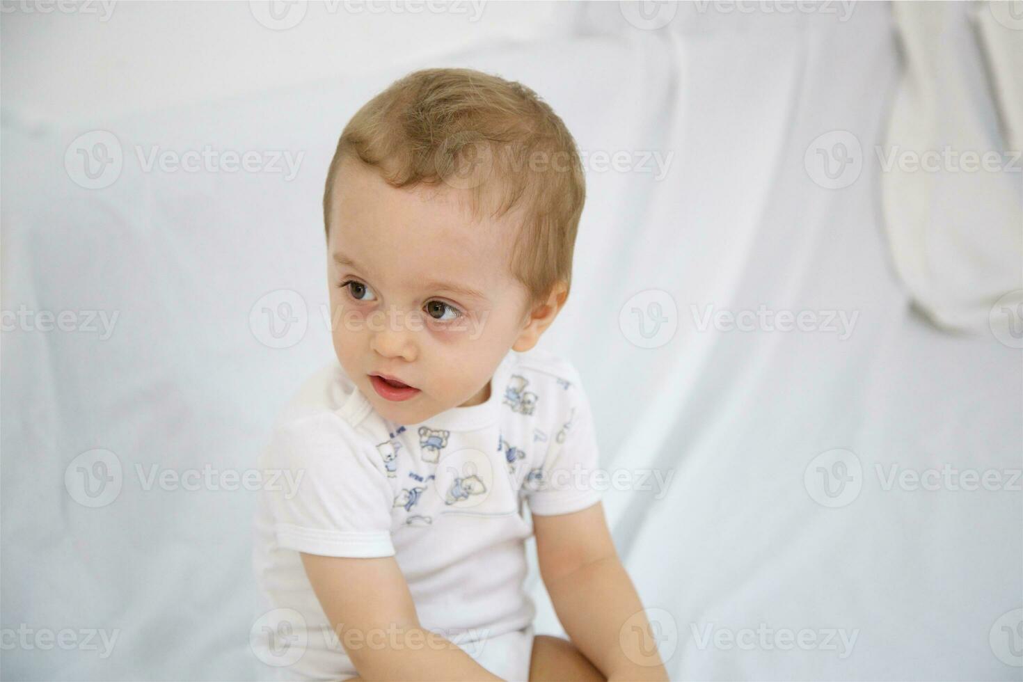 Boy of one year old is looking aside. photo