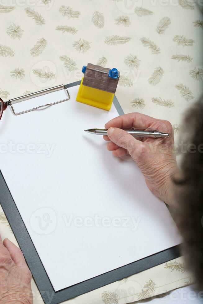 Old woman is writing something photo