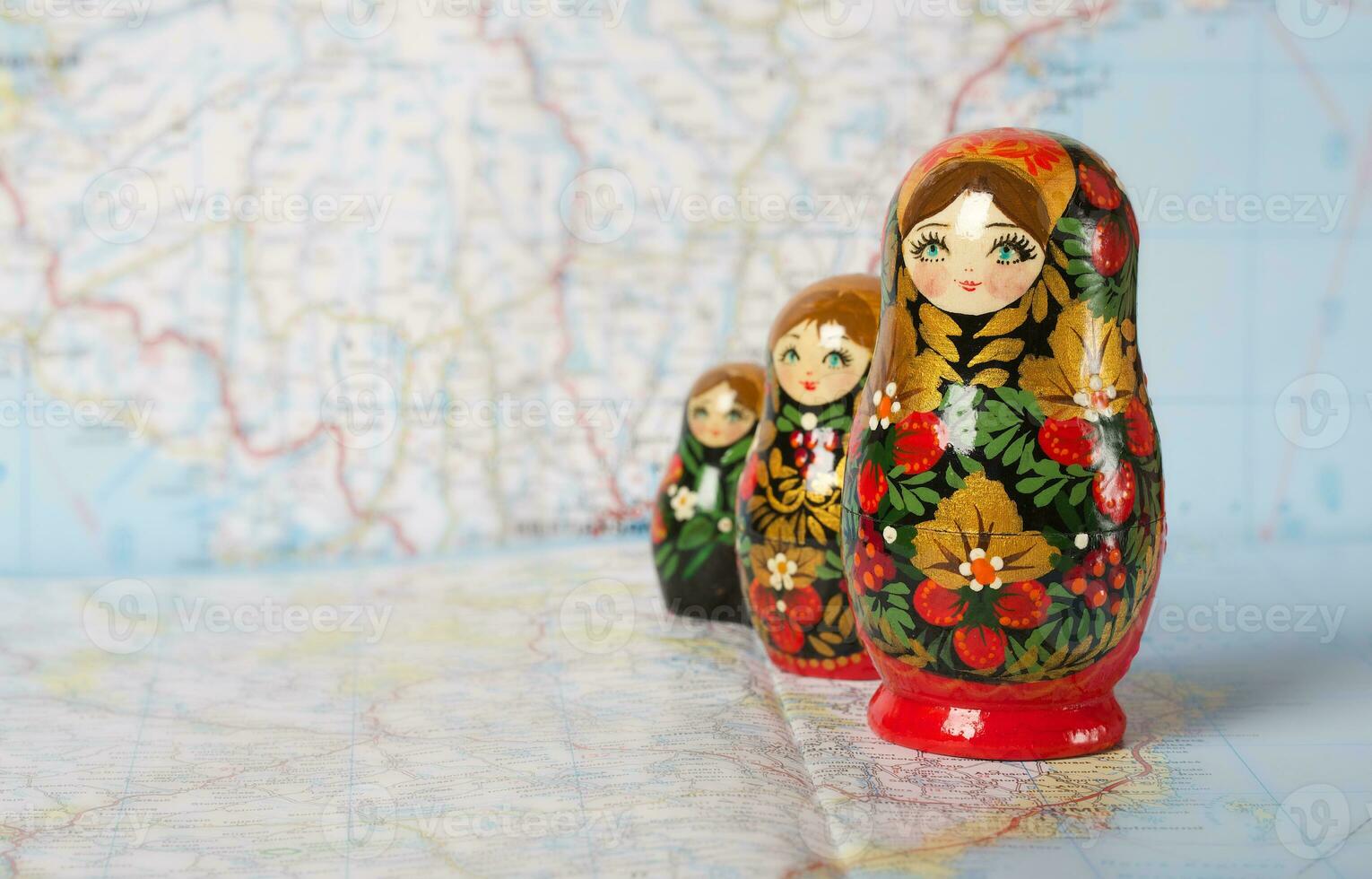 Russian matryoshka in khokhloma style on a map. Closeup photo