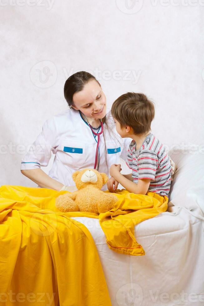 A child and a paediatrician in her cabinet photo